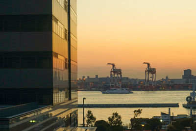 Buildings in city at sunset