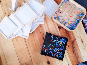 High angle view of multi colored umbrellas on wooden table