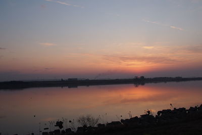 Scenic view of lake against sky during sunset