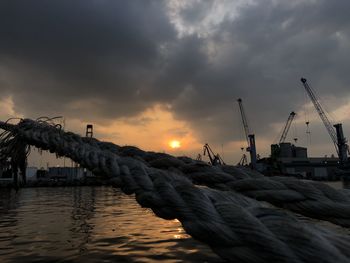 Sailboats in sea against sky during sunset