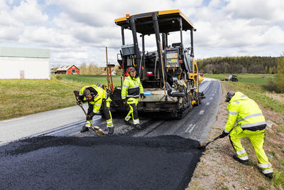 Workers putting new road surface