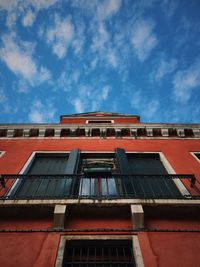 Low angle view of building against cloudy sky