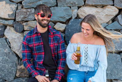 Smiling couple enjoying beer