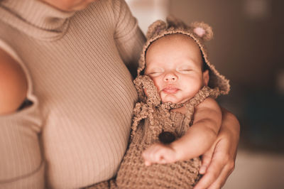 Midsection of mother holding baby