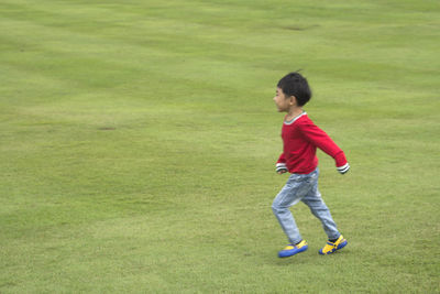 Boy running on field