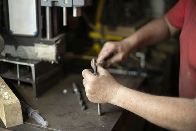 Midsection of man working in kitchen