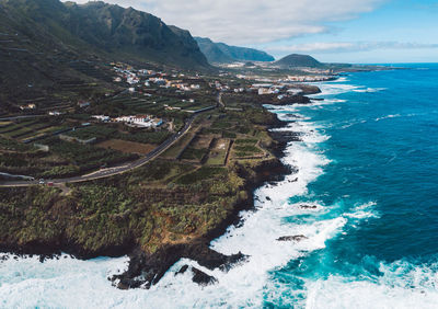 High angle view of island shore against sky