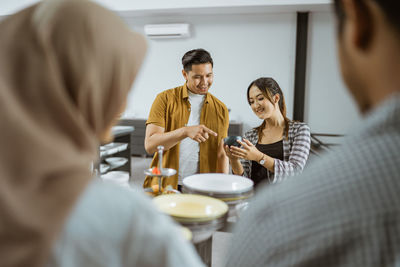 Businesswoman using mobile phone while sitting at table