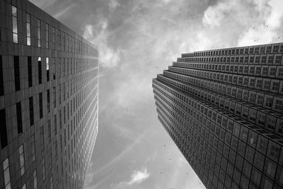 Low angle view of modern building against cloudy sky