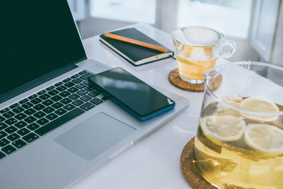 Morning time at home healthy breakfast laptop and phone on table. natural meal and drink at work