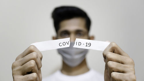 Close-up portrait of young man against white background