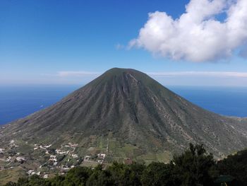 Scenic view of volcano against blue sky