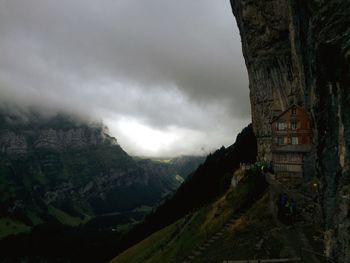 Scenic view of mountains against cloudy sky