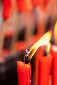 Close-up of lit candles on metal