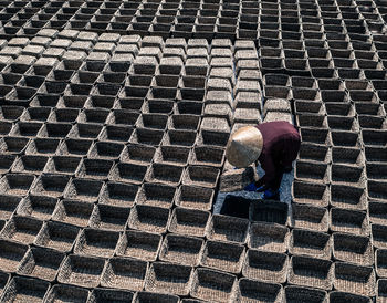 High angle view of farmer arranging baskets