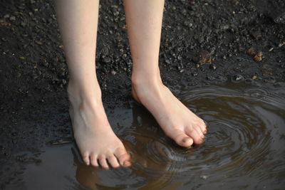 Low section of person legs in lake