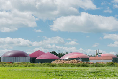 Houses on field against sky