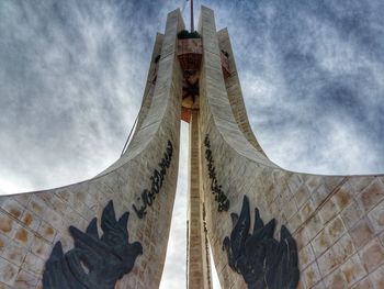 Low angle view of building against cloudy sky