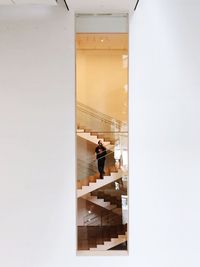 Man and woman on staircase in building