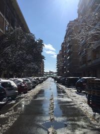 Cars on road amidst buildings in city