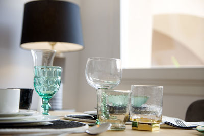 Close-up of wine glasses on table at home