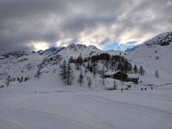 Scenic view of snow covered mountains against sky
