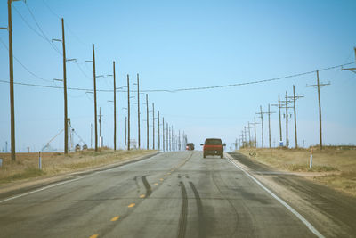 Cars on road against clear sky