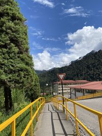 Road leading towards mountain against sky