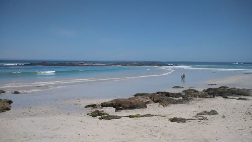 Scenic view of beach against clear sky