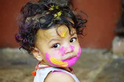 A cute baby with colourful face