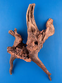 Low angle view of statue against blue background
