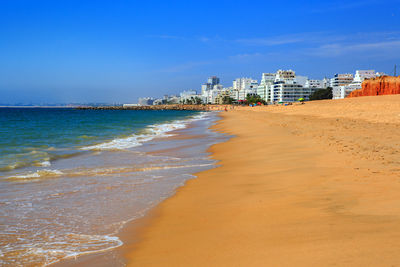 Scenic view of beach against sky in city