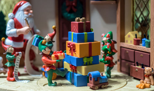 Children playing with toy toys on table, santa decorations.