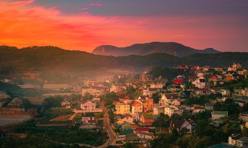 High angle view of townscape against orange sky