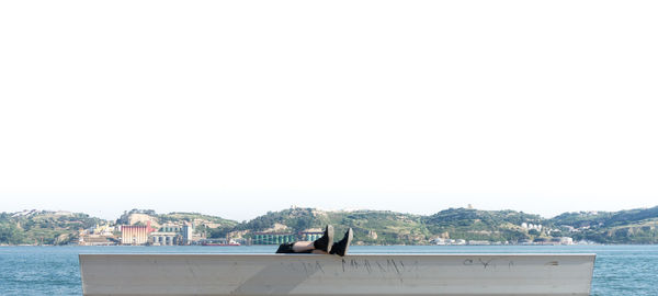 View of built structure by sea