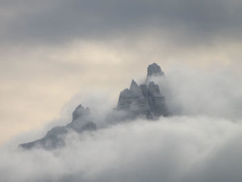 Scenic view of mountains against cloudy sky