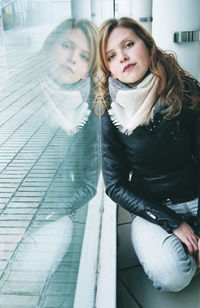 Portrait of a beautiful young woman sitting outdoors