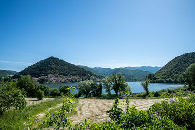 Scenic view of field against clear blue sky