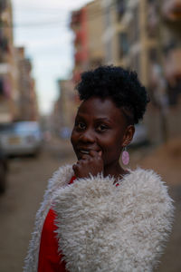 Portrait of woman standing on city street