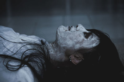 Close-up of zombie lying on floor