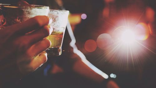 Cropped image of friends toasting drinks