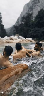 High angle view of people relaxing on rocks