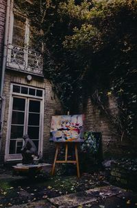 Table and chairs in yard against building