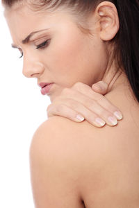 Close-up of young woman against white background