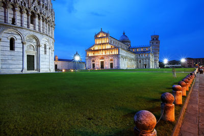 Pisa cathedral and leaning tower of pisa against blue sky at dusk