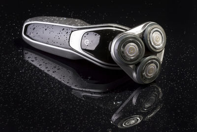 Close up of electric razor against black background