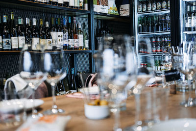 Wine tasting setup with array of bottles. foreground of empty wine glasses set for tasting 