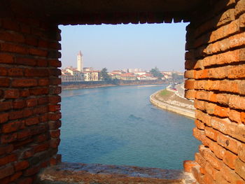 View of brick wall with buildings in background