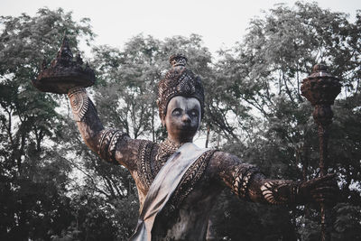 Low angle view of statue against sky