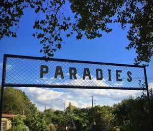 Low angle view of signboard against the sky